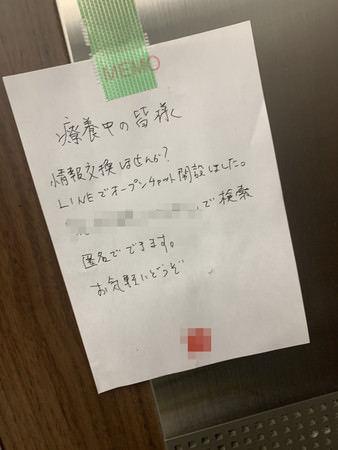 療養ホテル内のエレベーターホールに貼られたチャットの案内。ホテル室内 のメモに書かれている。
